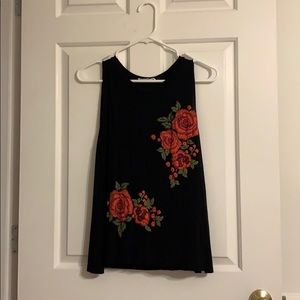 I am selling a black tank top with red roses.
